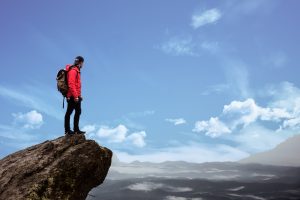 Image of a man standing on a cliff edge